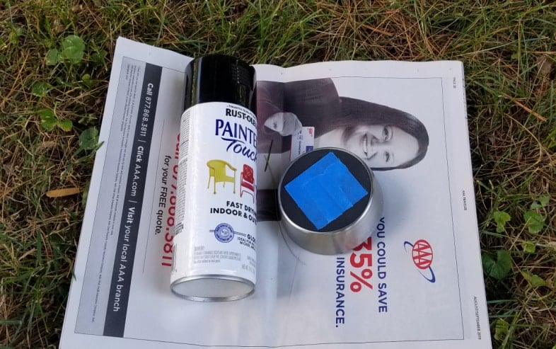 rustoleum spray paint and solar light top with blue painter's tape on it