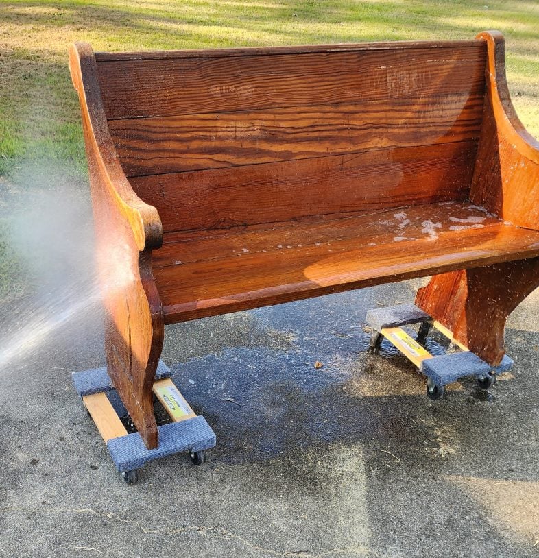water hose spraying the old pew
