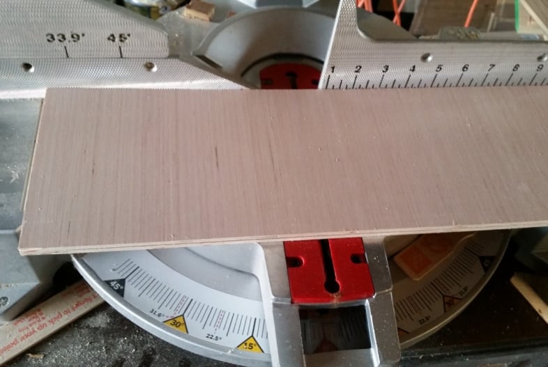 plywood being cut on miter saw