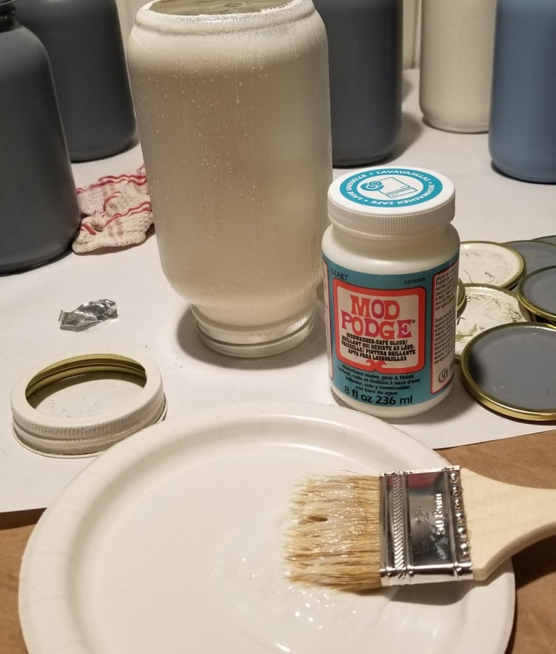 mod podge and paint brush on a plate