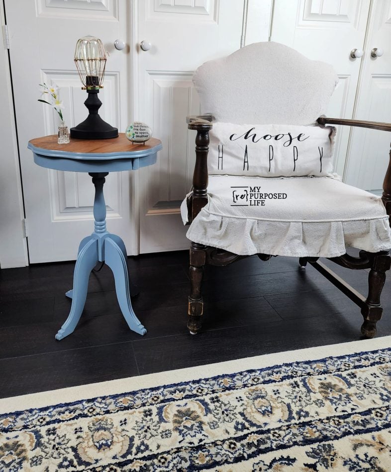 blue parlor side table sitting next to a parlor chair