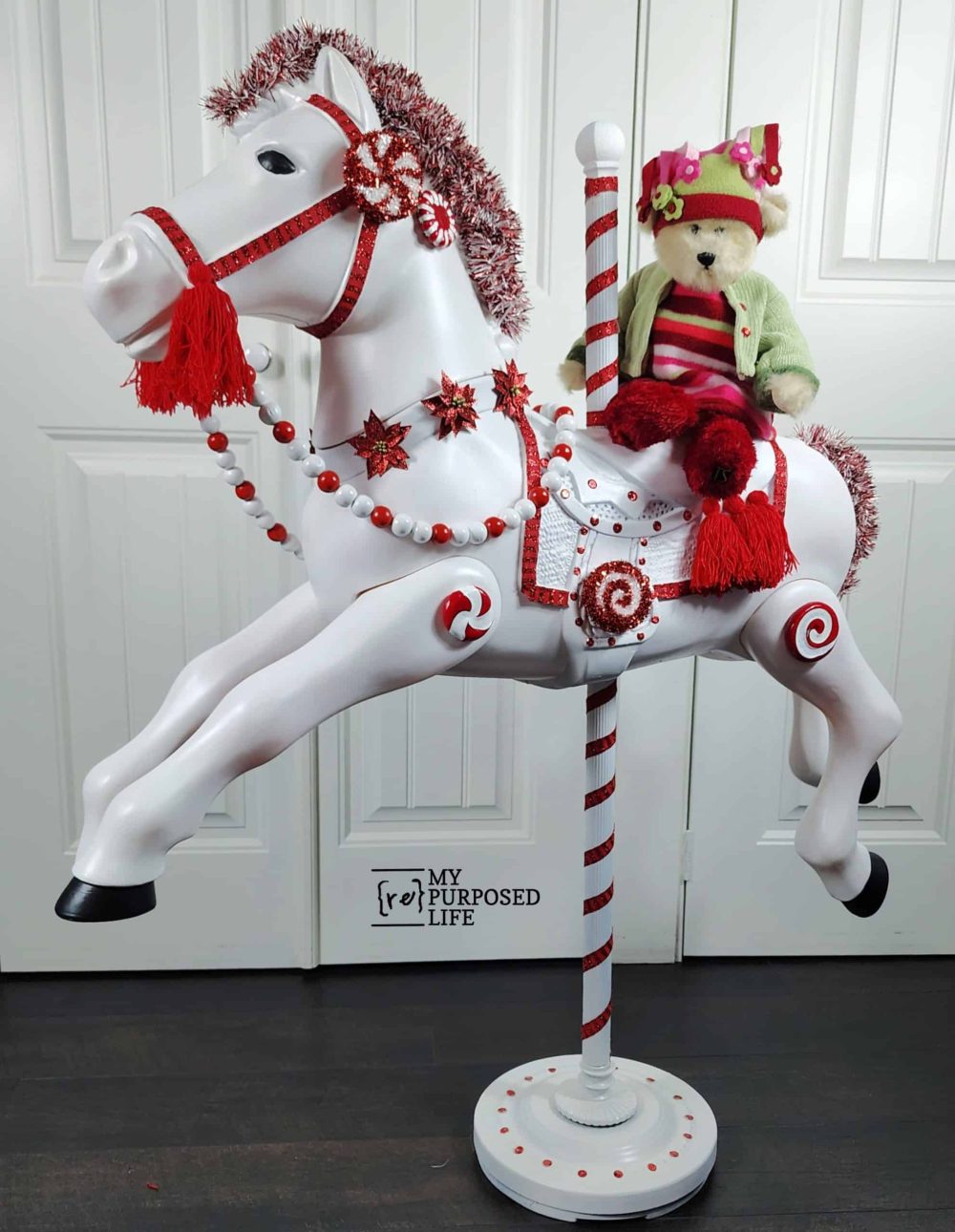 stuffed bear sitting on a hobby horse turned into a carousel horse