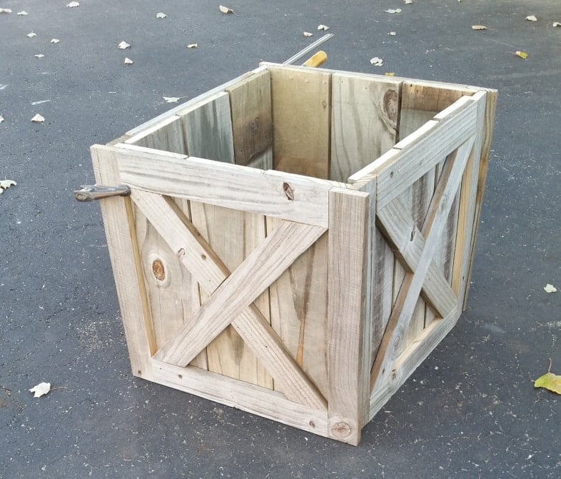 diy rustic Christmas tree stand box with a clamp holding it together