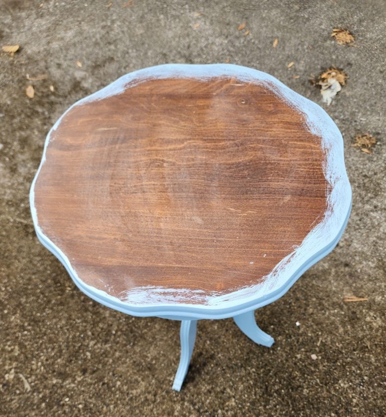 brown table top with just the outer edge painted blue