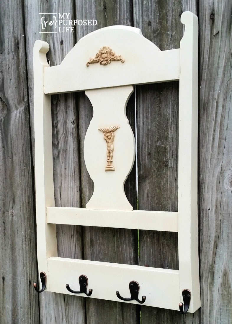 white chair back wall coat rack anging on a fence