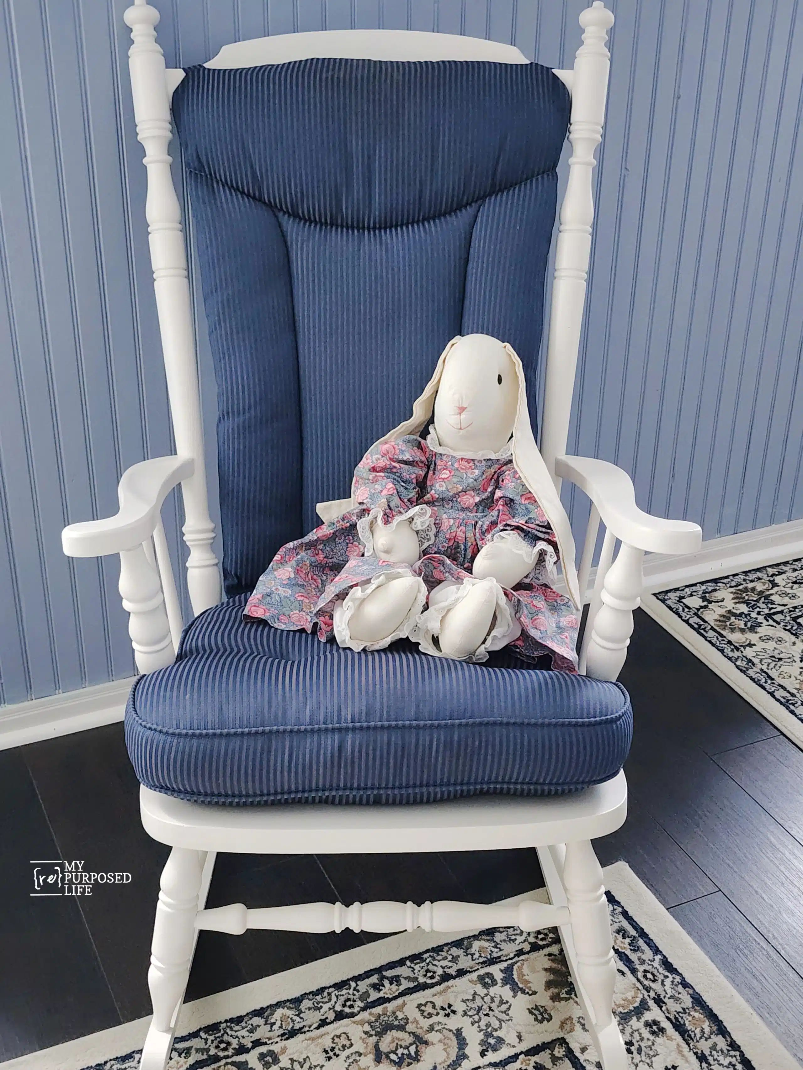 white wooden rocking chair with blue cushions