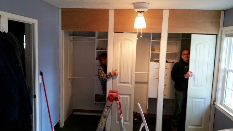 man and woman hiding behind closet doors