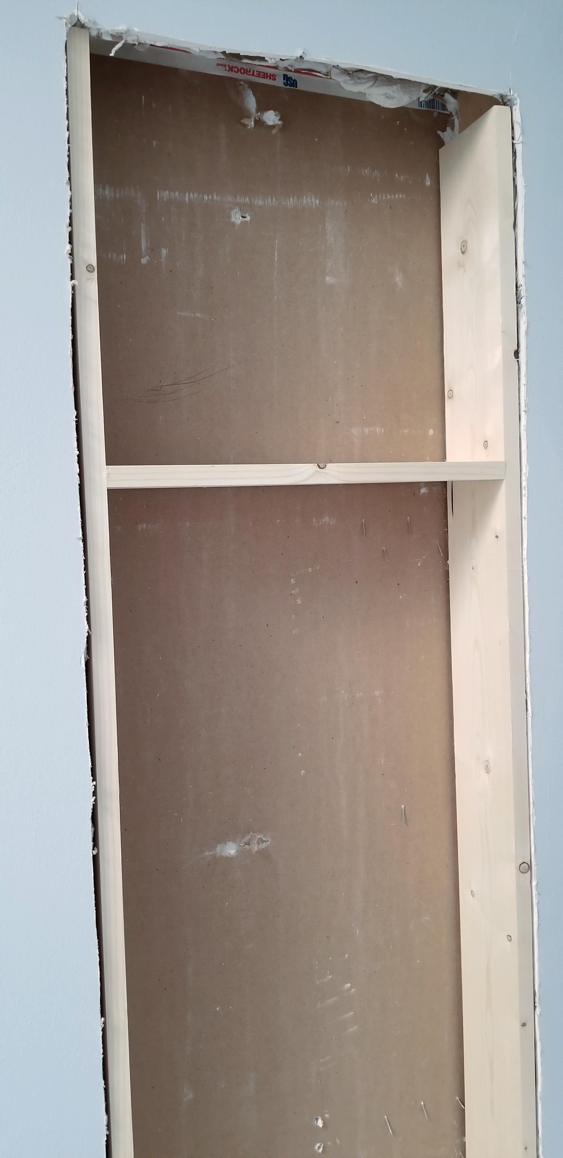 new lumber boxing in the rough fit between the studs broom closet