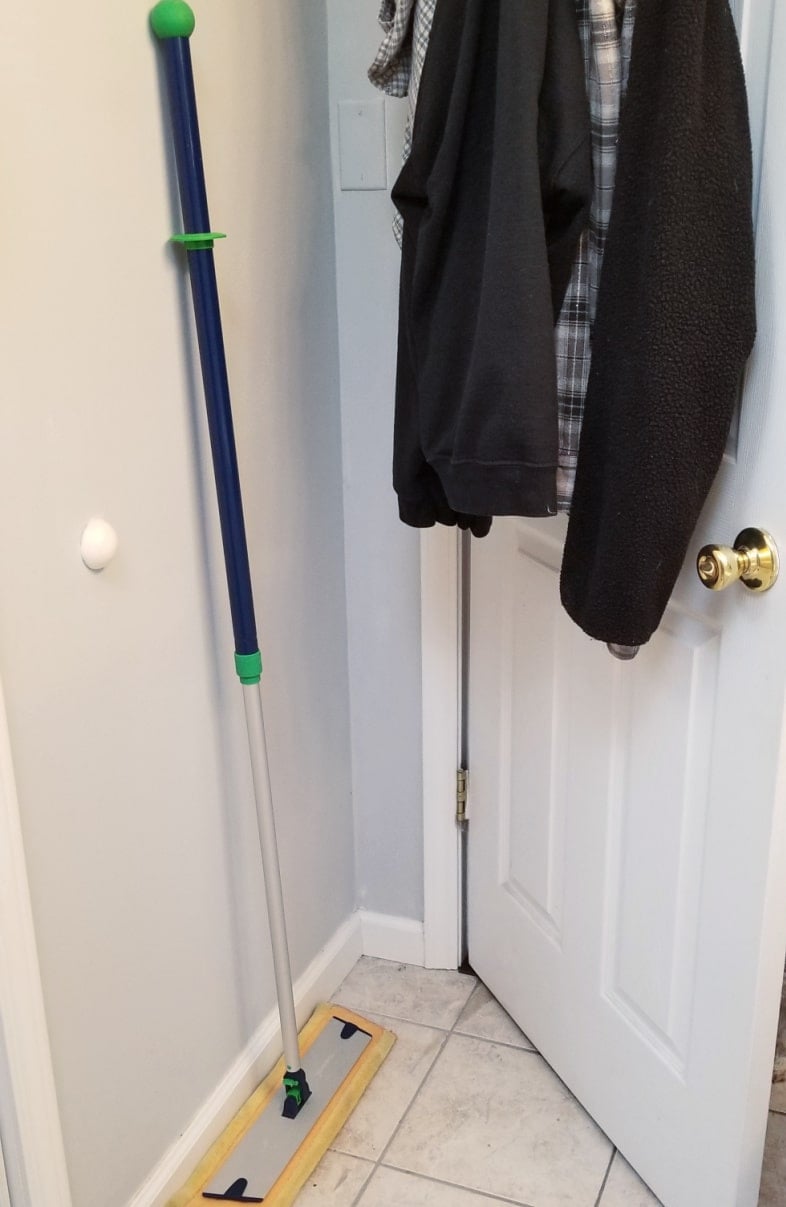 floor duster behind bathroom door