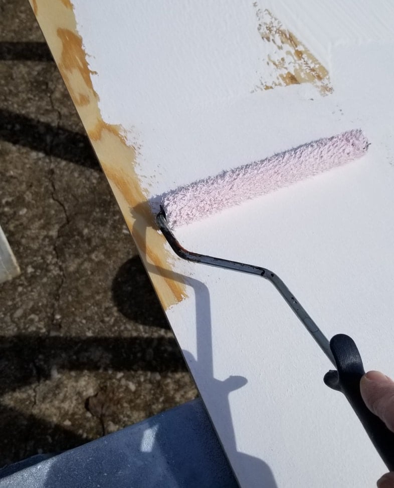 a small roller painting the between the studs closet insert