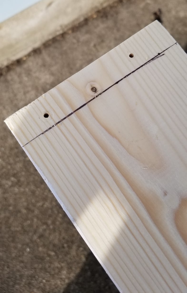 pilot holes drilled in end of board