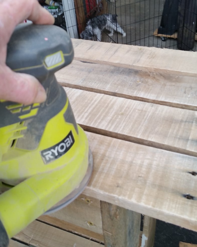 sanding one pallet potting bench boards