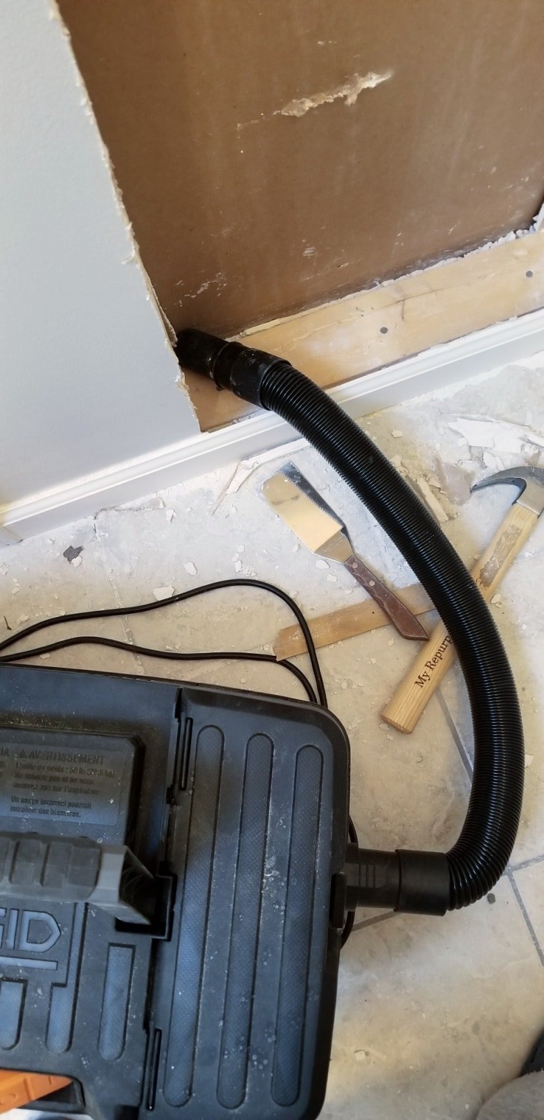 wet dry vac cleaning up a mess