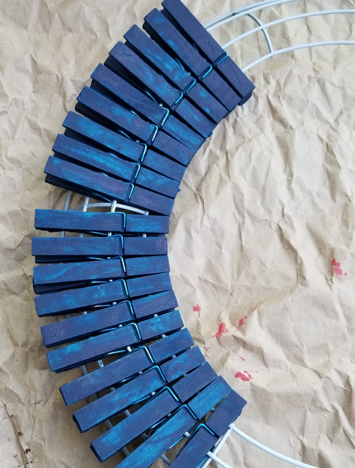 clip blue clothespins onto white wreath form