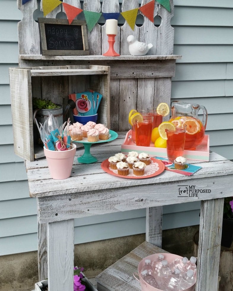 white potting bench as a party station with drinks and snacks