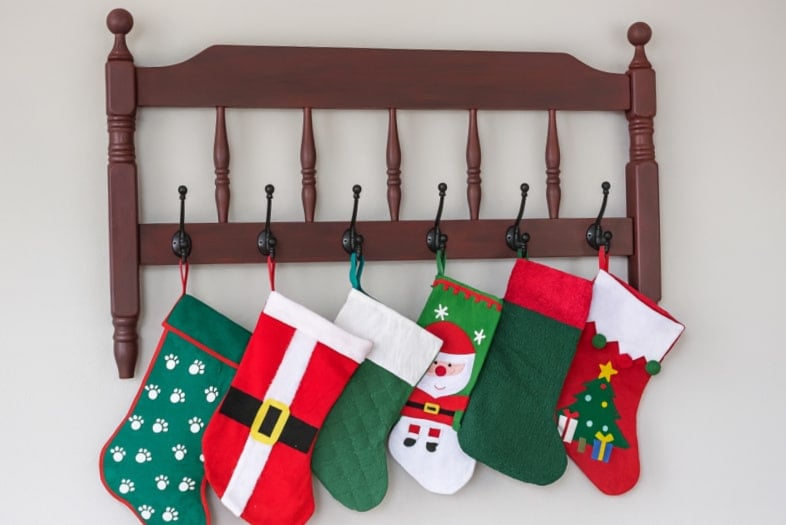 Red footboard coat rack with Christmas stockings