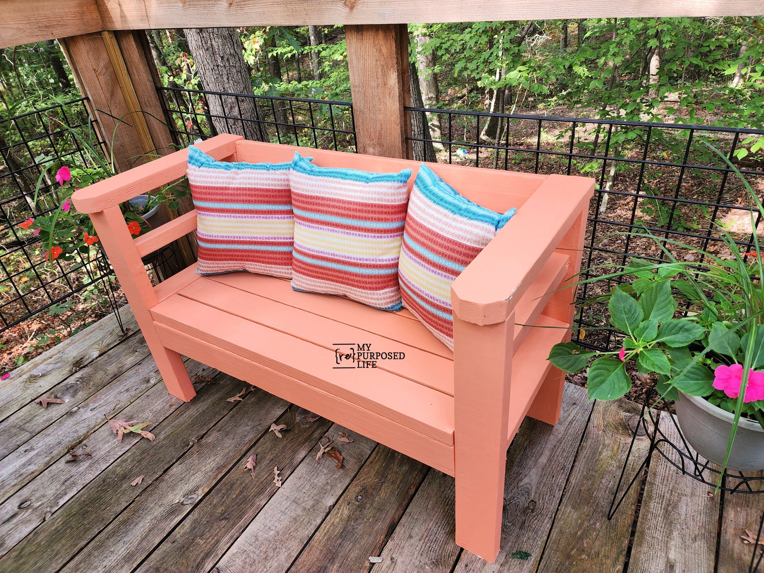 orange outdoor sofa with striped pillows