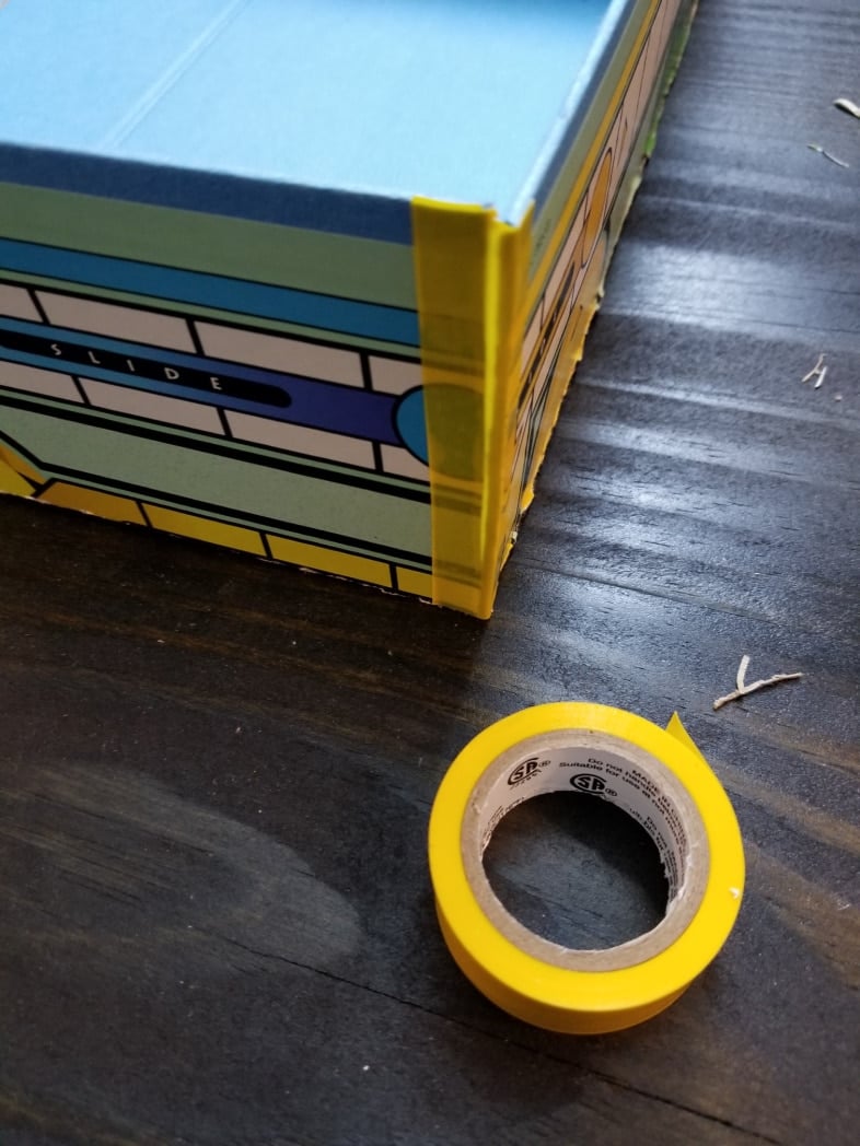 yellow electrical tape on sorry gameboard box