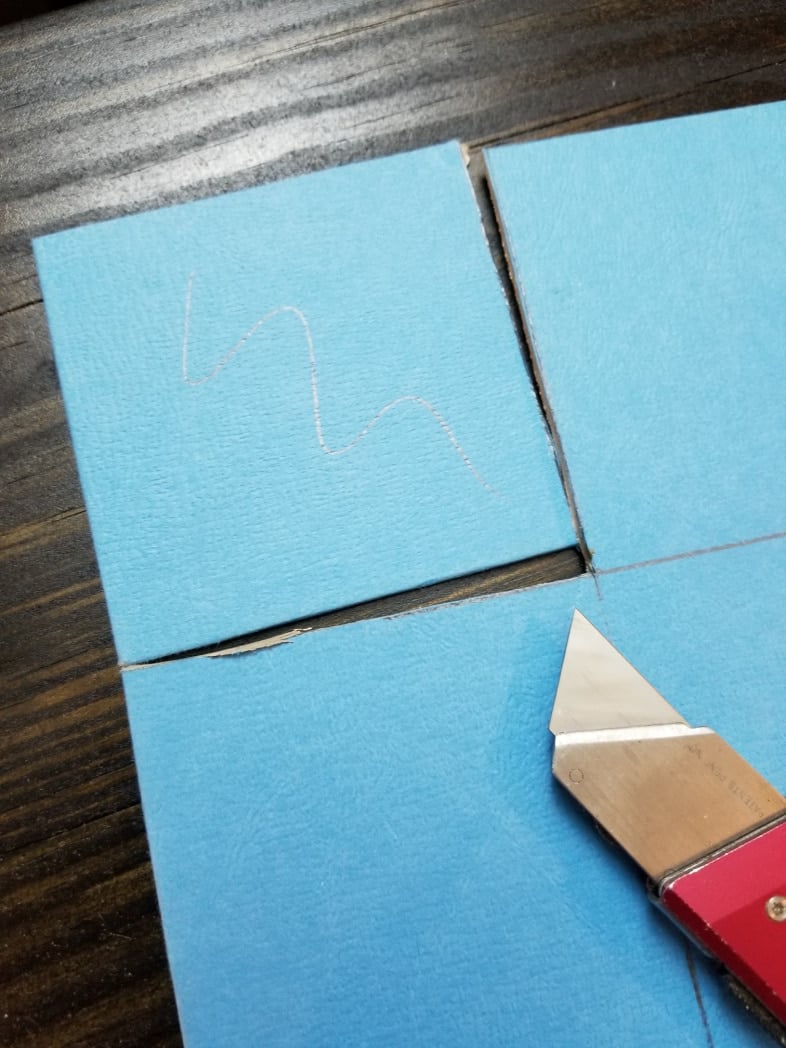 cutting a game board with a utility knife