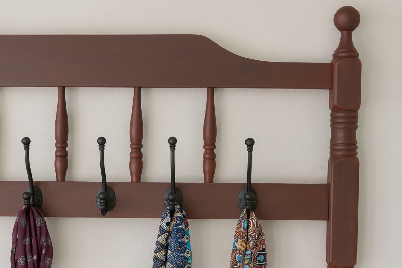 red coatrack with scarves haning on the hooks