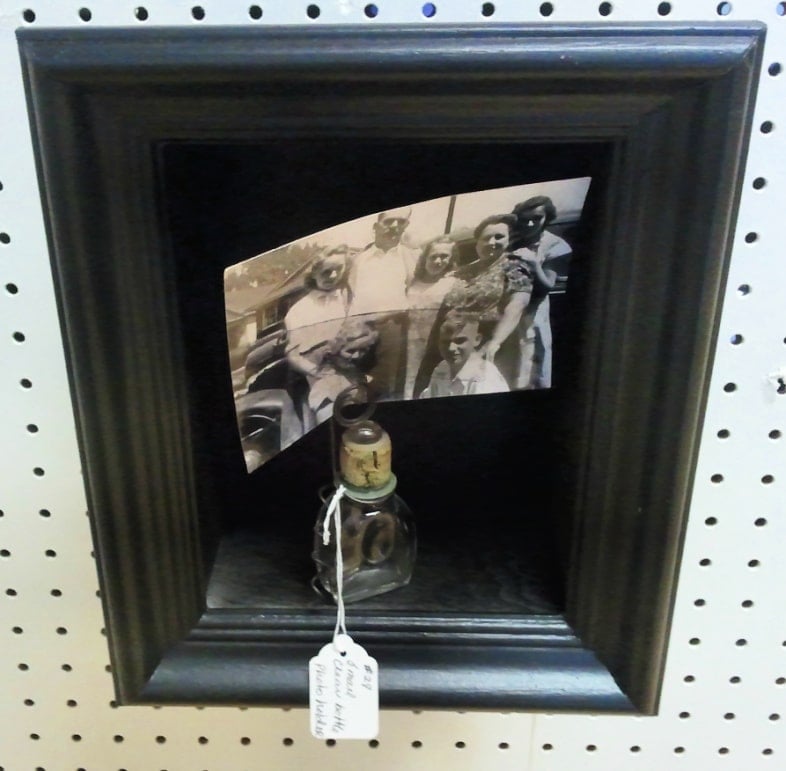 small black shadow box frame for sale at a booth