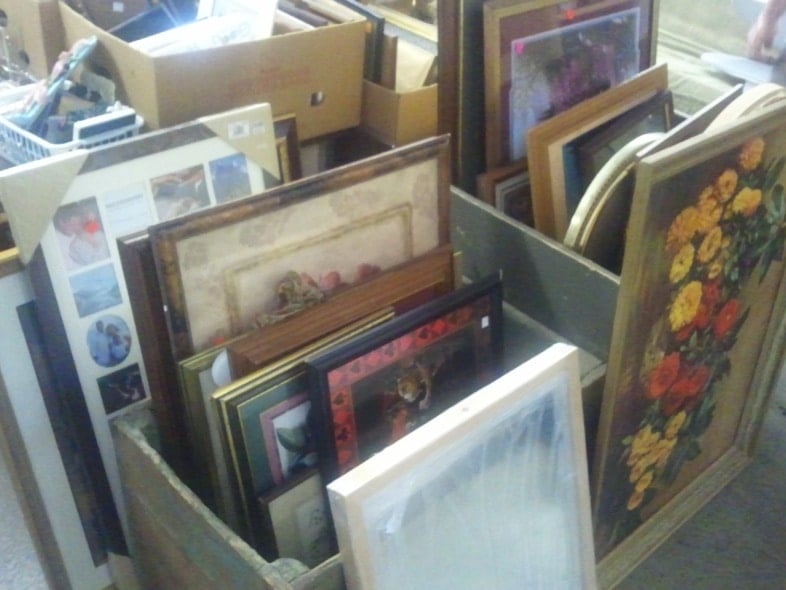 a collection of thrift store picture frames bein sold