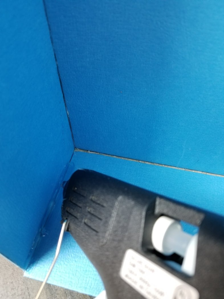 hot glue on seams of cardboard box