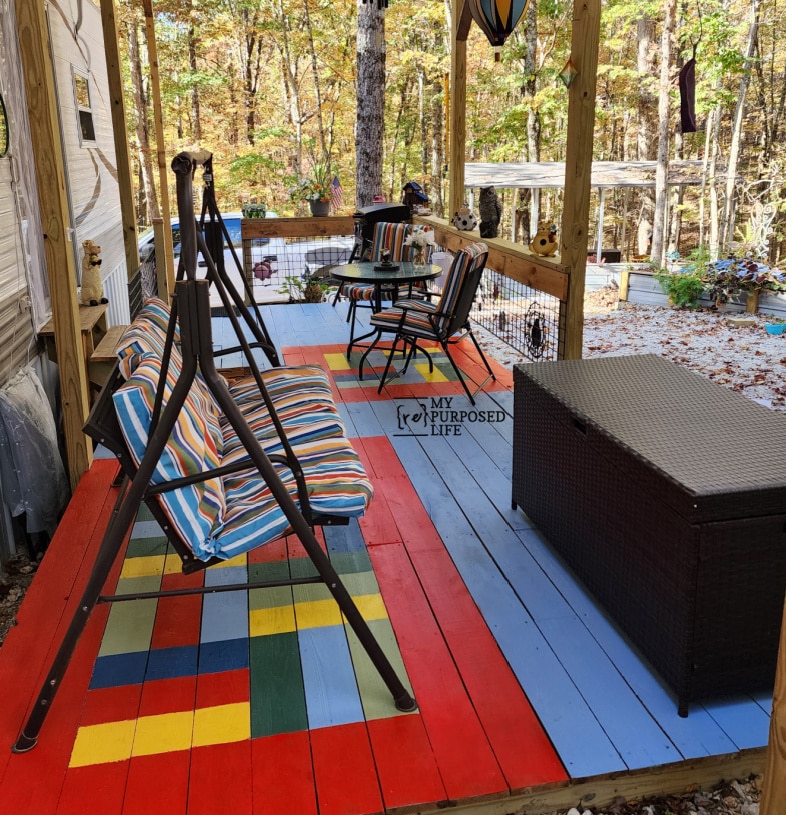 small porch with swing table and chairs deck box