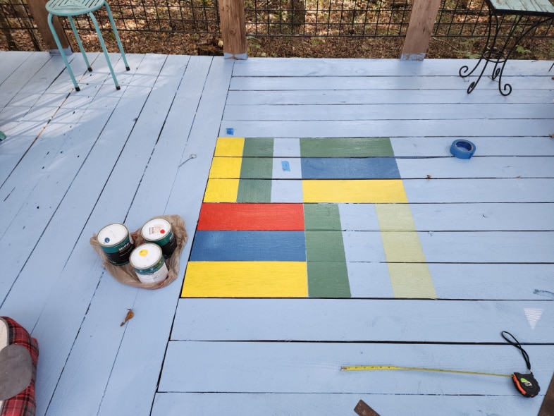 geometric painted shapes on a blue deck