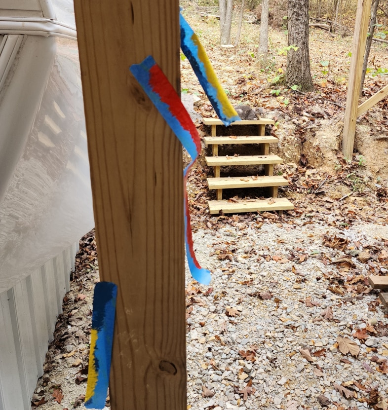 used painter's tape hanging on porch post
