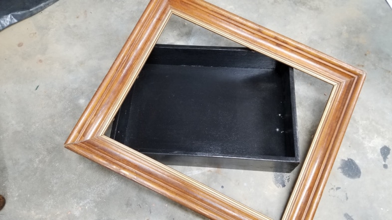 picture frame resting on a drawer