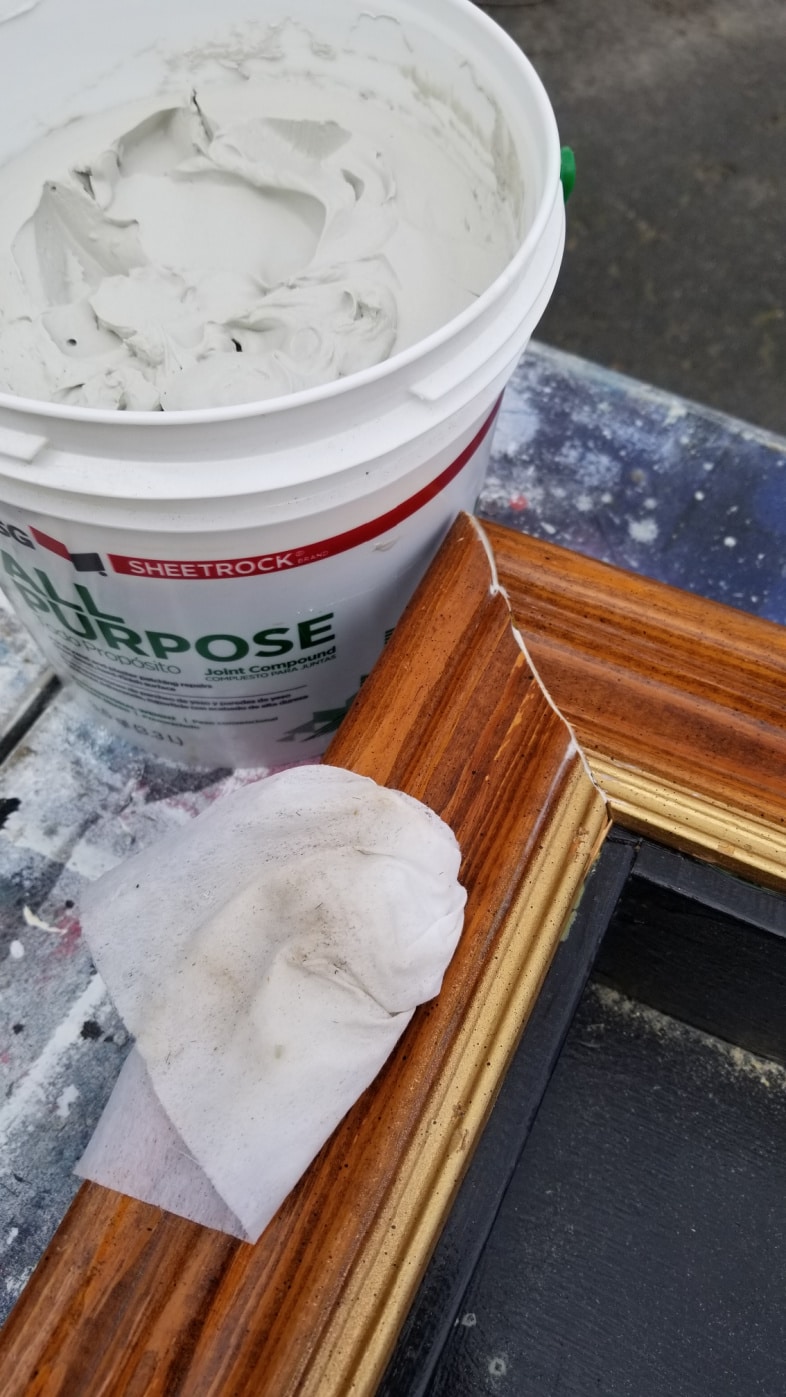 a bucket of drywall mud and a baby wipe