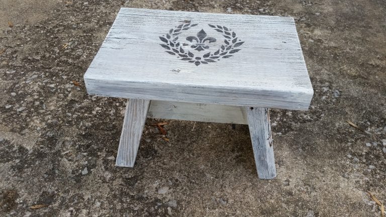white wooden stool with a fleur0de-lis stencil