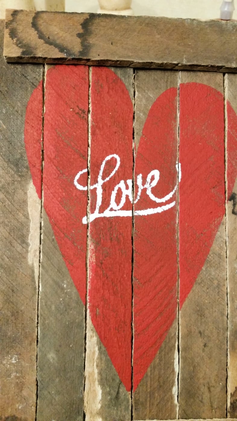 red heart with love written in white