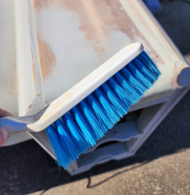hand brush dusting top of vanity after sanding