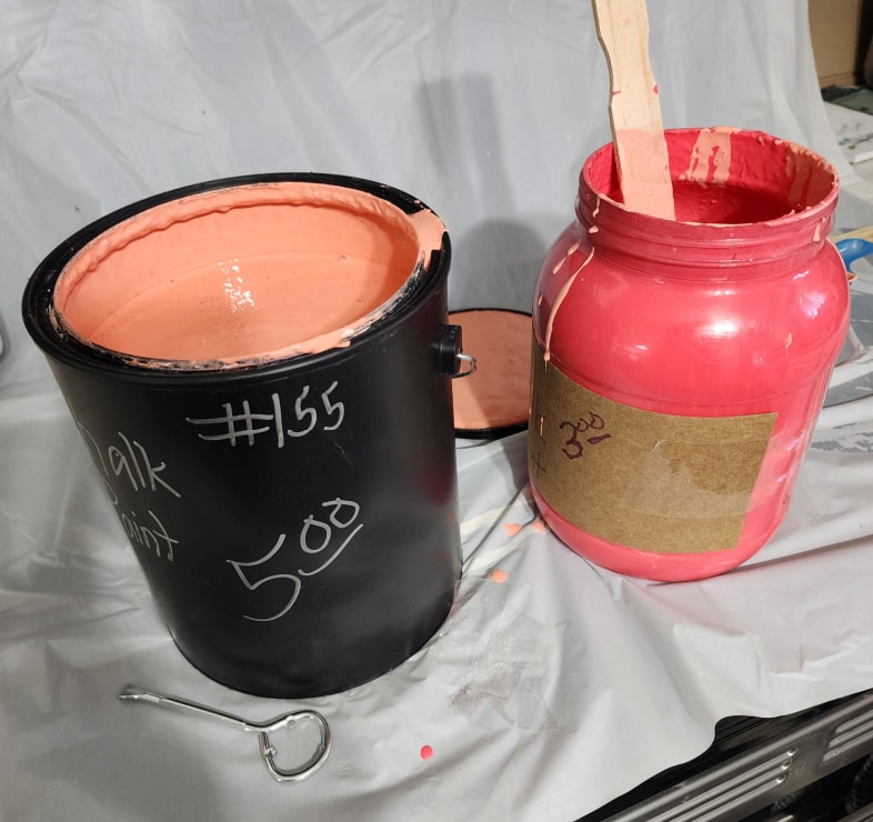 mixing two different colors of pinkish paint
