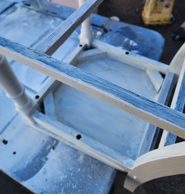 chair resting on a table upside down for painting