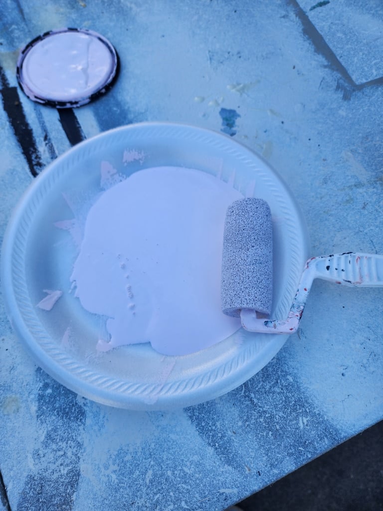paint, paint roller on a styrofoam plate