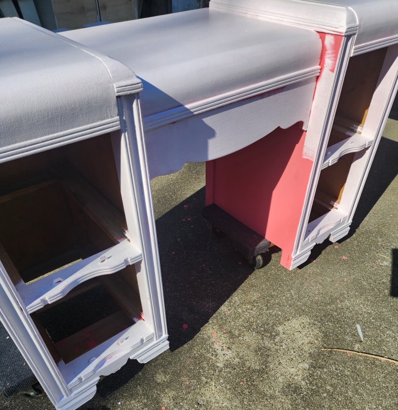 bright pink art deco vanity getting a lighter color of pink paint