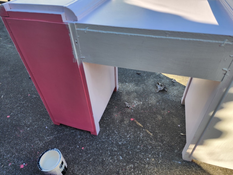 back of bright pink desk gets white paint