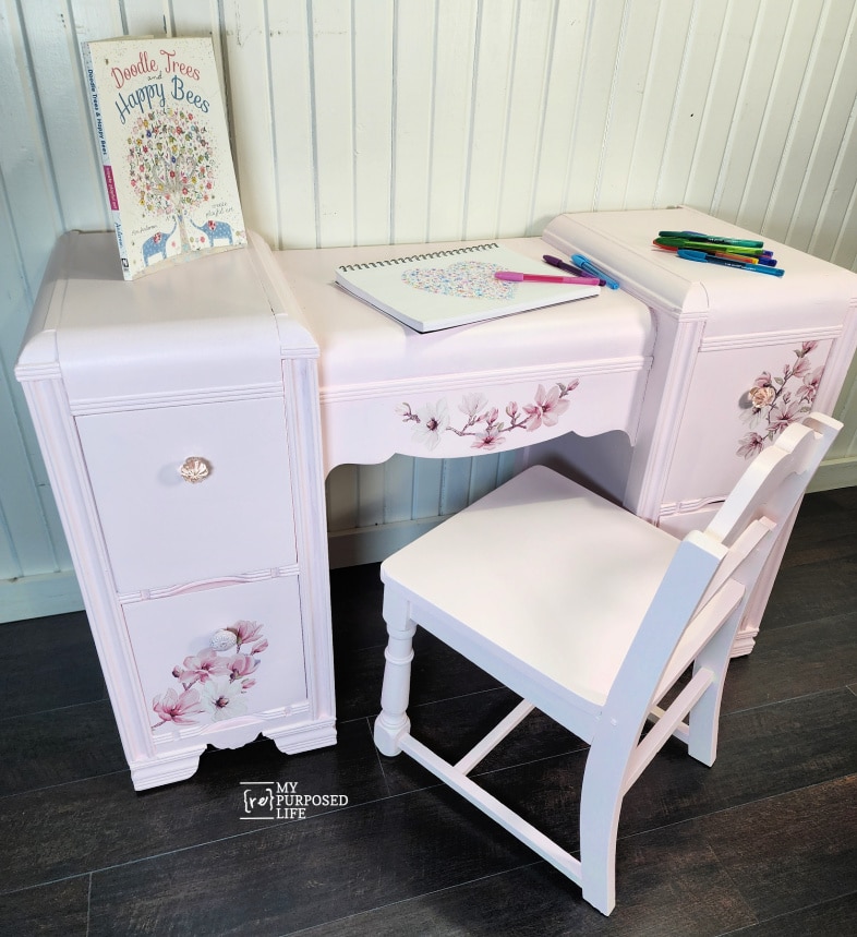 pink desk and chair with doodle art supplies