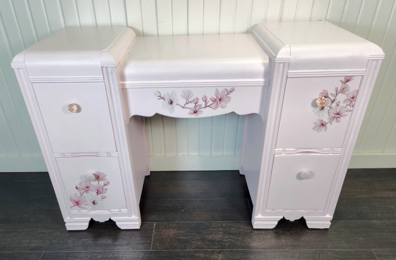 front view of pink desk with flower transfers on the drawers and front