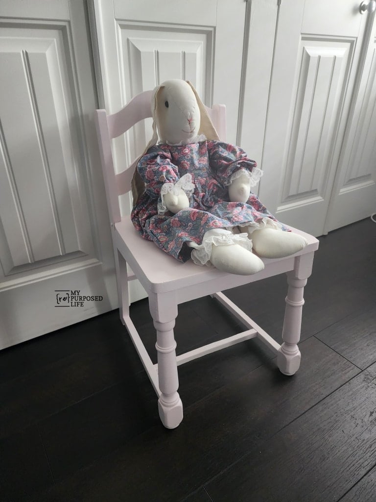 small pink chair with stuffed rabbit