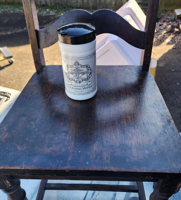 canister of surface prep wipes resting on the seat of a chair