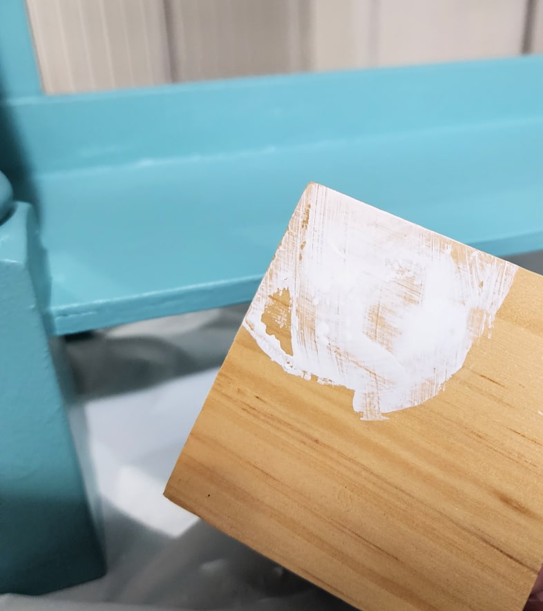 white paint on the corner of a wooden block