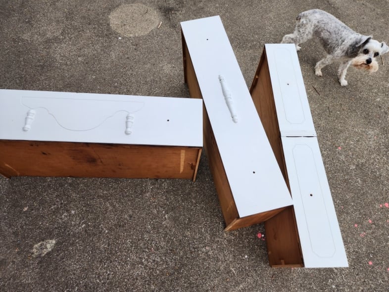 three antique dresser drawers with first coat of light gray paint