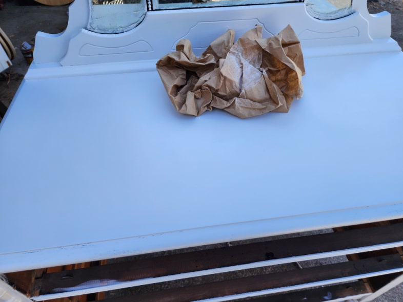 brown craft paper crumpled up on painted dresser top