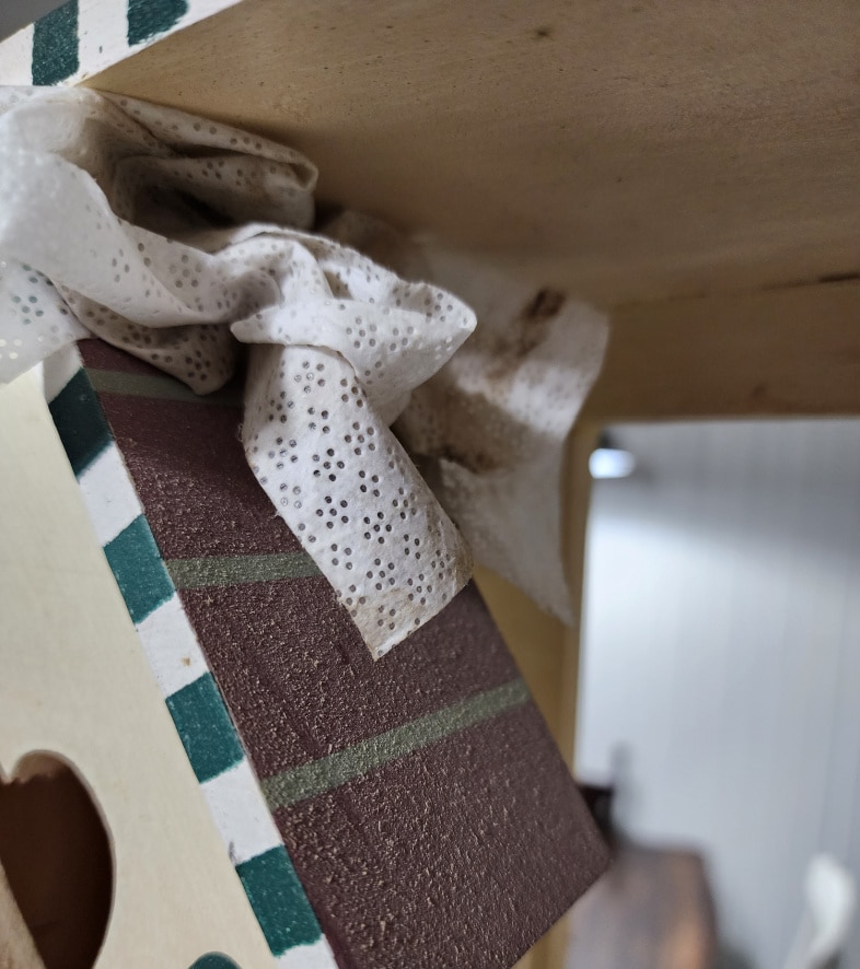 wipe dusting off shelf