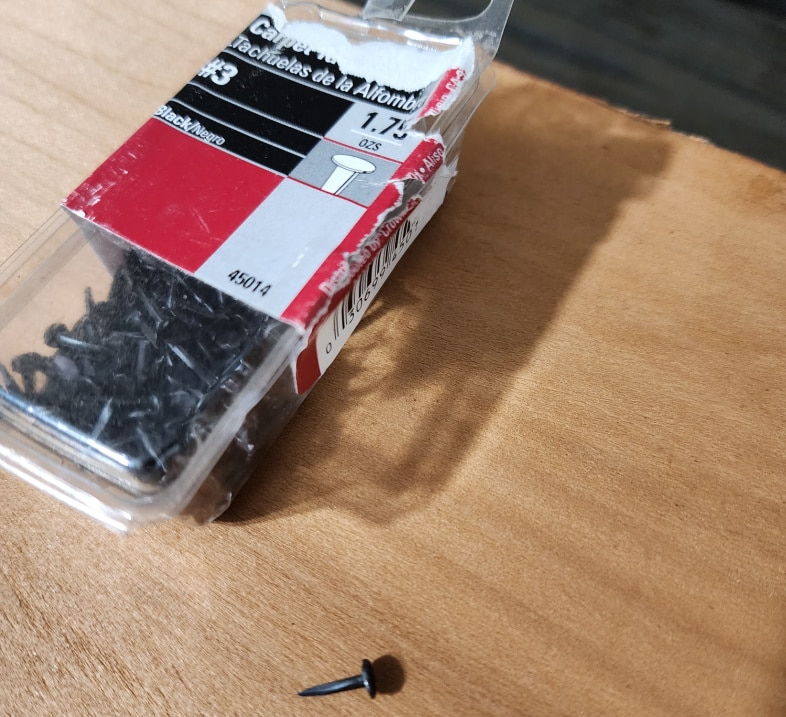 a package of black tacks or nails