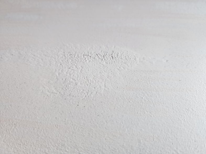 antique dresser top with gray paint bubbled up